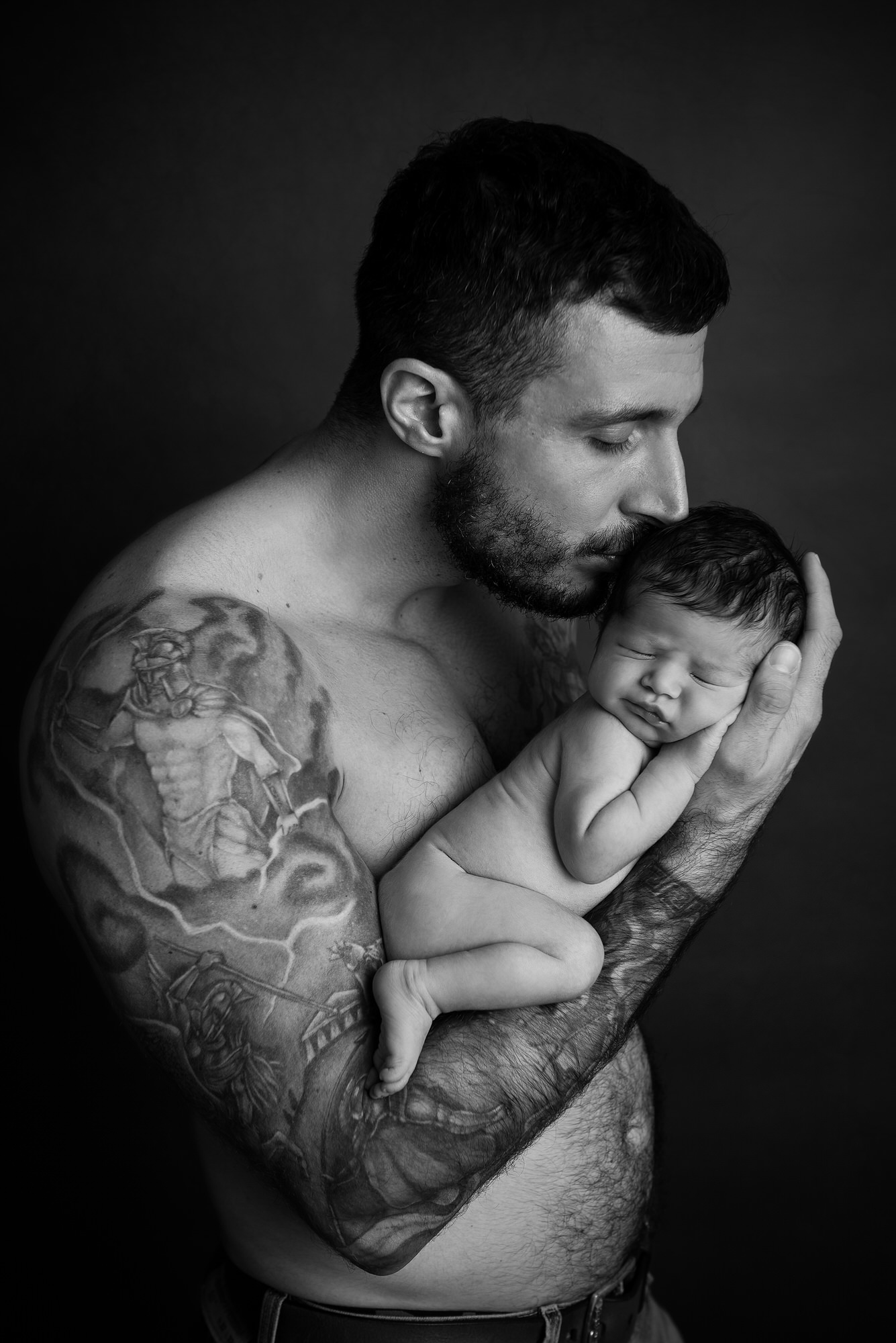Dad holding newborn black and white photography